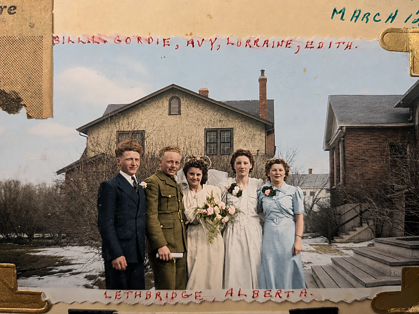 Colourised 1943 wedding-party photograph: a young soldier and his bride with their attendants, outside a house in the melting snow.